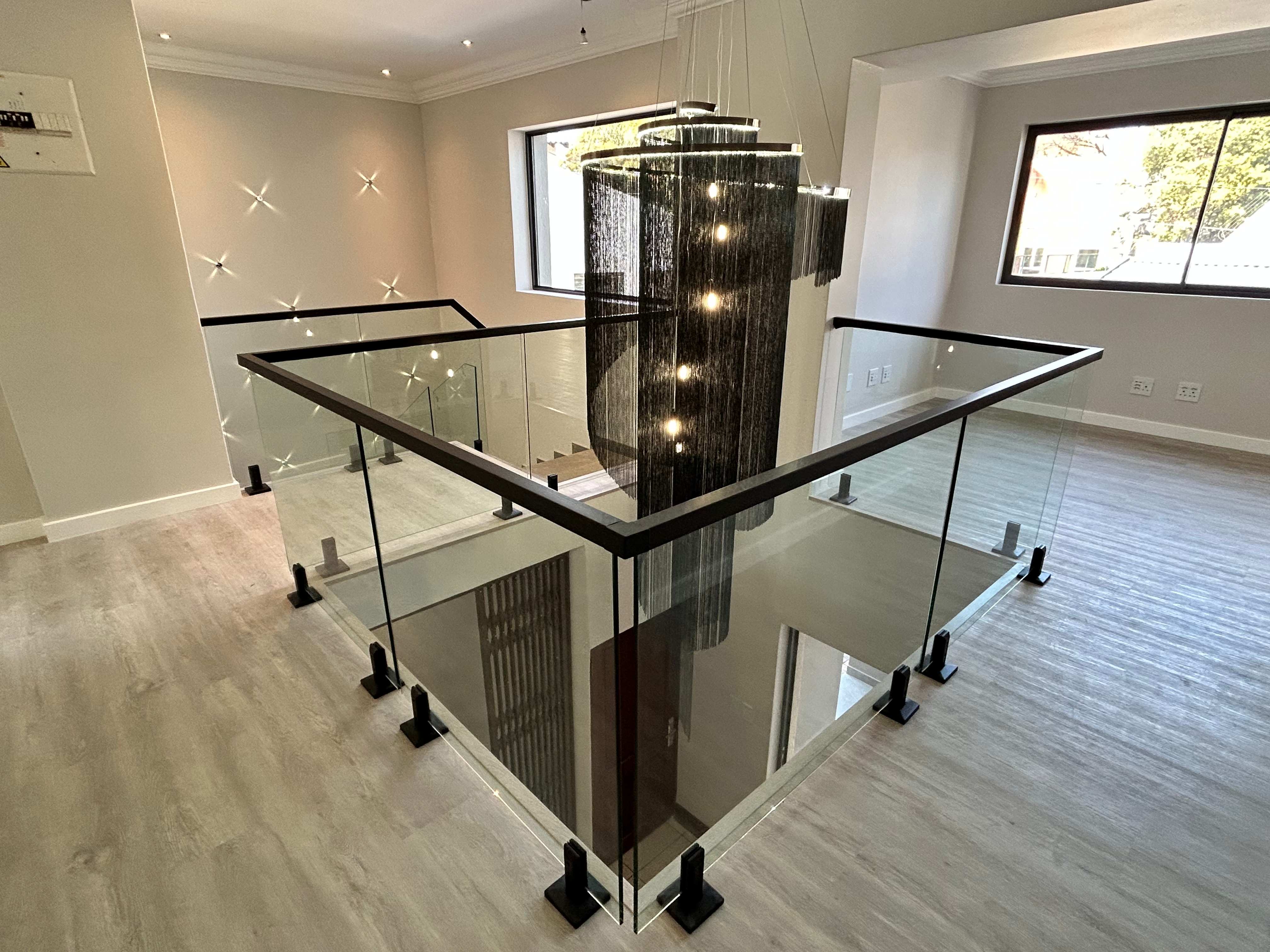 Home renovation project featuring elegant staircase with chandelier